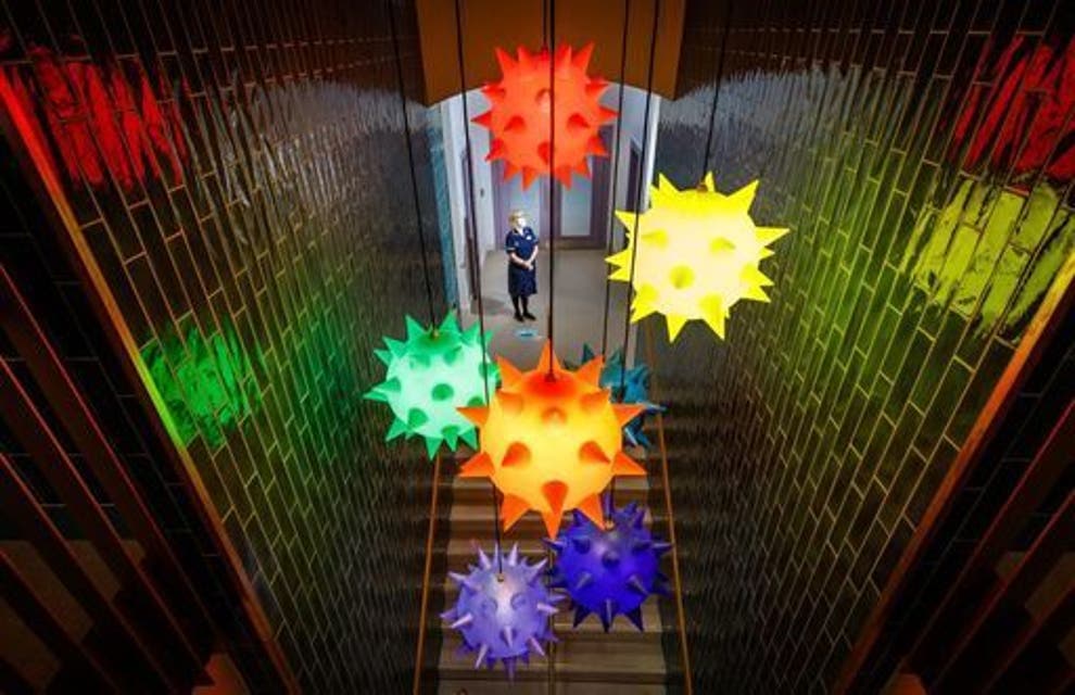 staircase with colourful virus-shaped light pendants